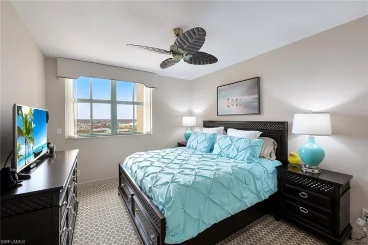Bedroom with baseboards, carpet, and a ceiling fan