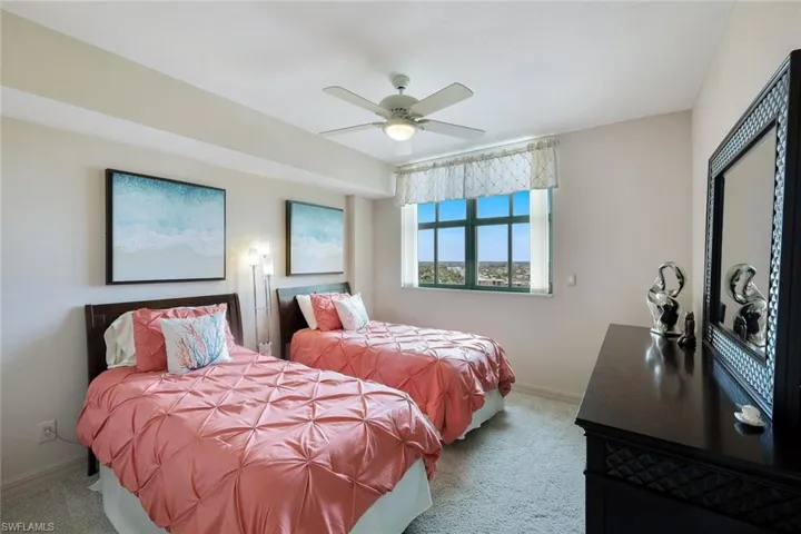 Carpeted bedroom featuring baseboards and ceiling fan