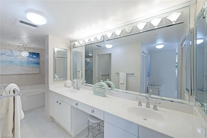 Full bathroom with visible vents, a sink, tile patterned flooring, and a garden tub