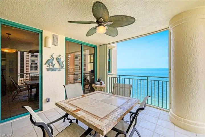 Sunroom / solarium with a water view and visible vents