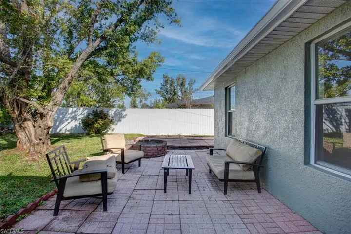 View of patio featuring an outdoor living space with a fire pit