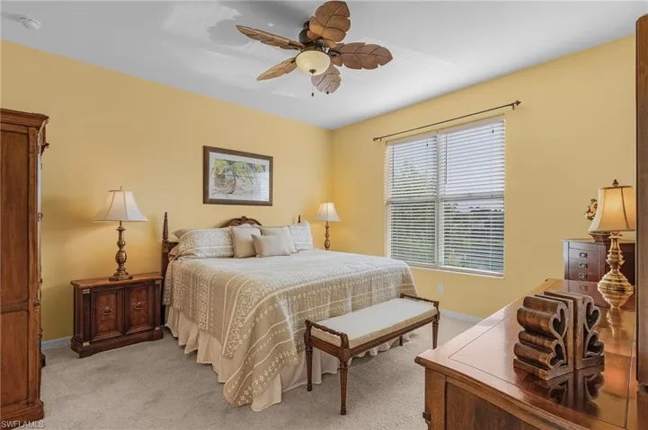 Bedroom with light carpet and ceiling fan