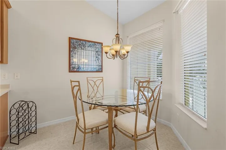 Dining space featuring a notable chandelier and lofted ceiling