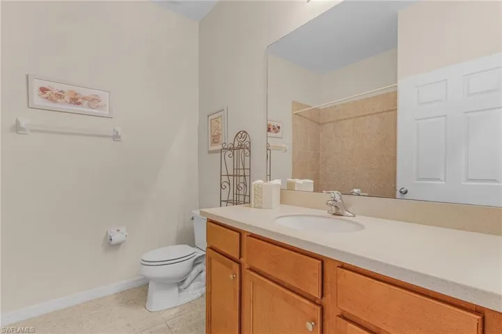 Bathroom featuring tile patterned floors, vanity, and toilet