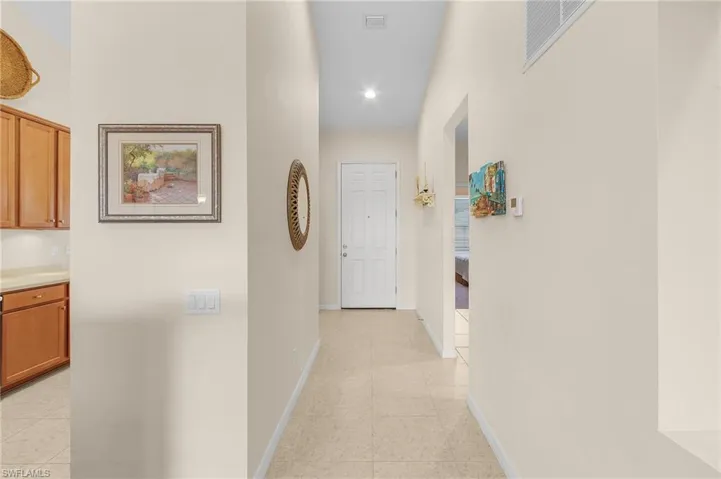 Corridor with light tile patterned floors