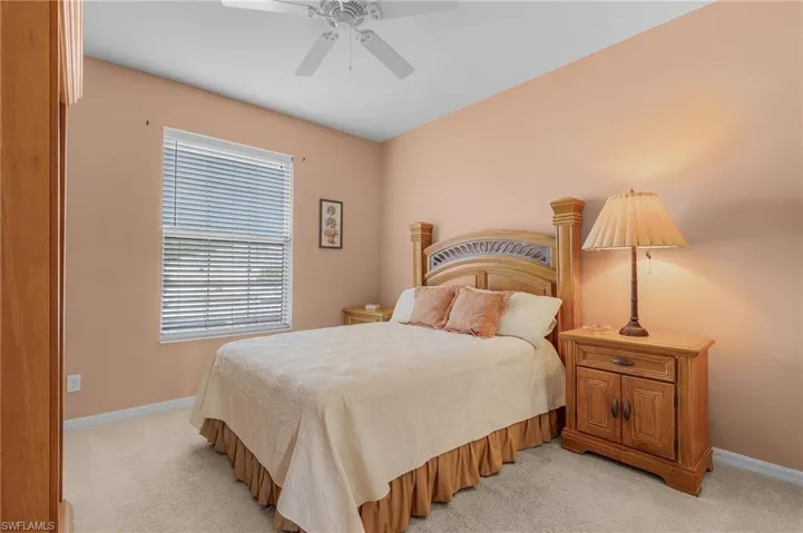 Carpeted bedroom with ceiling fan
