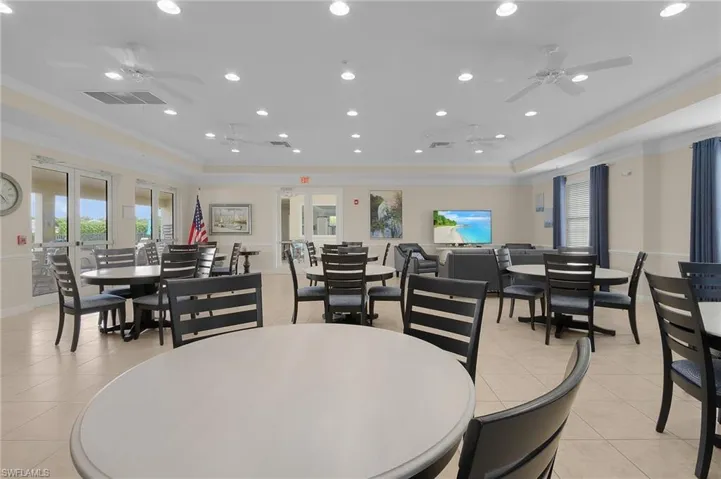 Tiled dining area featuring ornamental molding, ceiling fans.