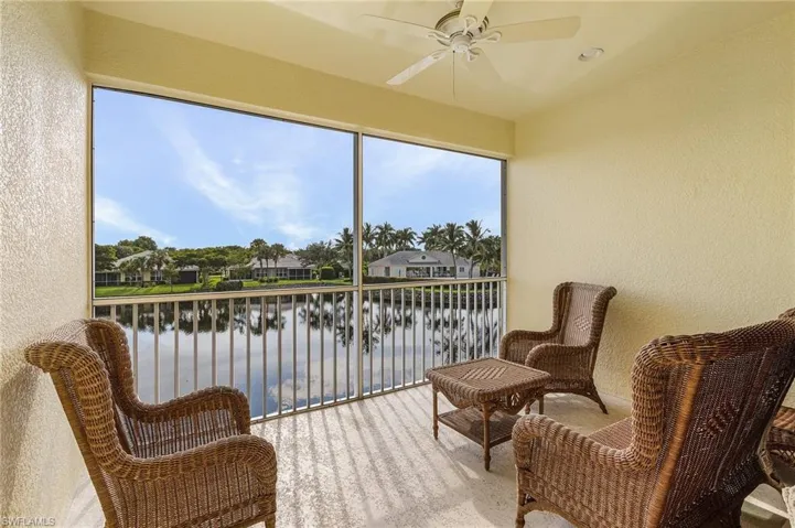 Lanai with ceiling fan and a water view