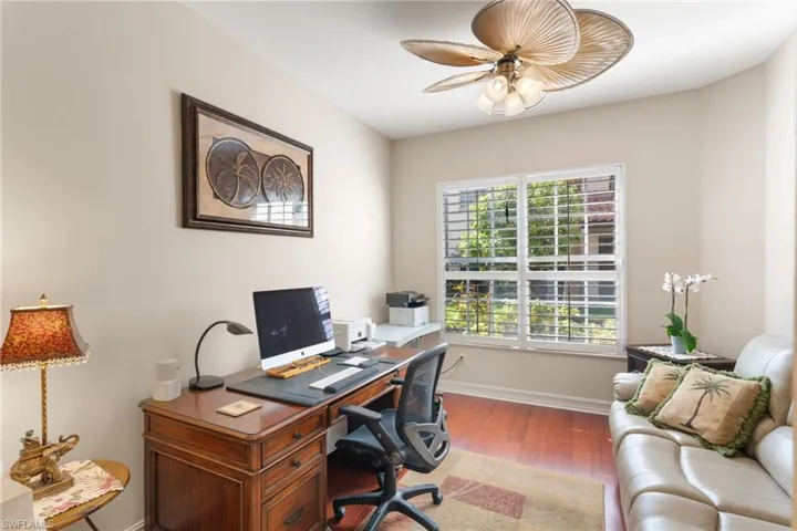 Home office with wood finished floors and ceiling fan