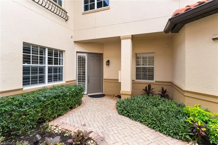 Doorway to property featuring stucco siding