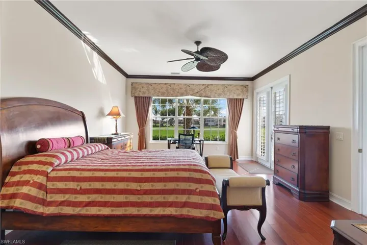 Bedroom with access to outside, crown molding, wood-type flooring, and a ceiling fan
