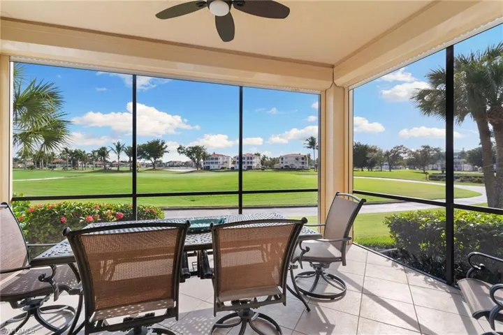 Sunroom with golf course view and tile patterned flooring