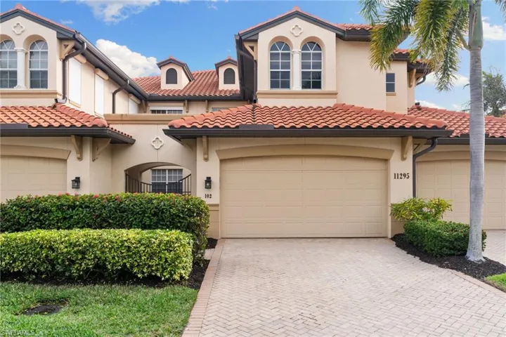 Mediterranean / spanish-style home with stucco siding, decorative driveway, and a tiled roof