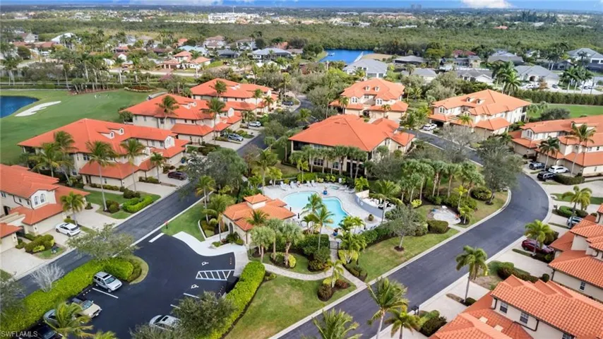 Aerial view of property and surrounding area with nearby suburban area and a nearby body of water