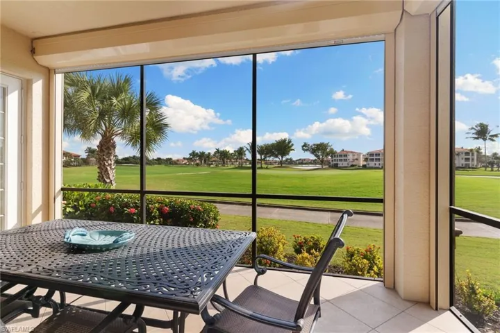 Sunroom / solarium featuring golf course view and outdoor dining space