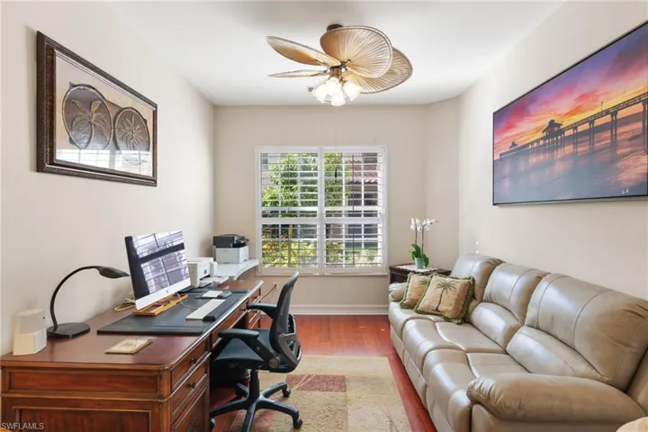 Office area featuring light wood-type flooring and a ceiling fan