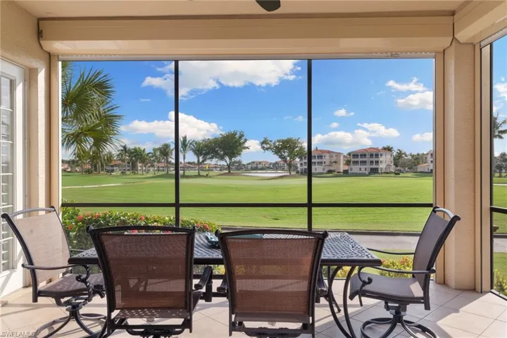 Sunroom featuring golf course view and tile patterned flooring