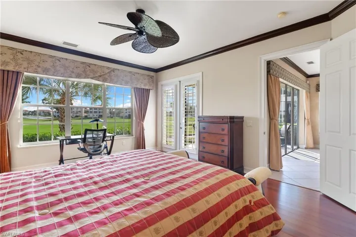 Bedroom with access to outside, ornamental molding, hardwood / wood-style flooring, and ceiling fan