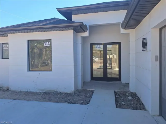 Property entrance featuring french doors