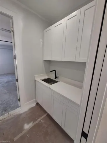 Clothes washing area with sink