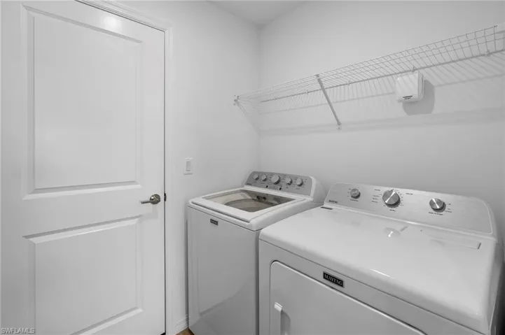 Washroom with washing machine and clothes dryer