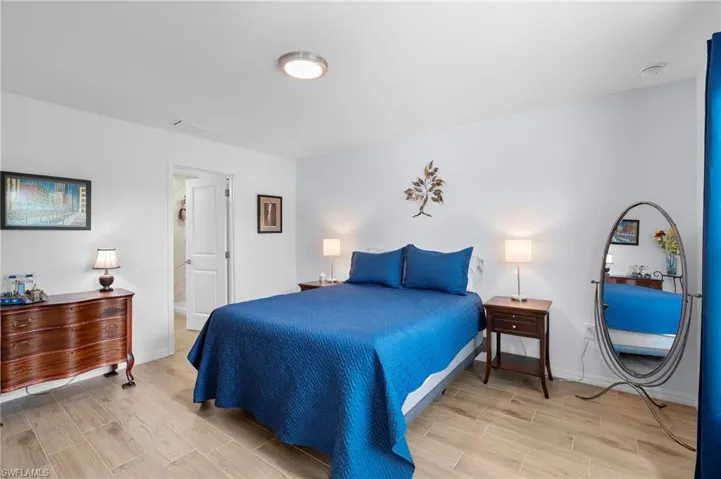 Bedroom with wood finish floors and baseboards