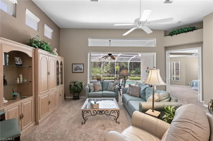 Living room featuring ceiling fan and light colored carpet