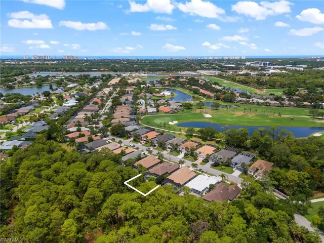Birds eye view of property with a water view