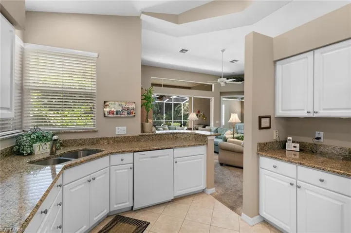 Kitchen featuring white dishwasher, sink, a wealth of natural light, and ceiling fan