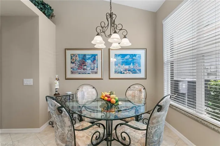 Dining space featuring a chandelier and light tile floors