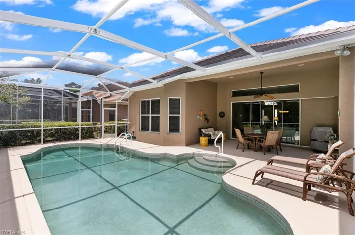 View of pool with a patio, a lanai, and ceiling fan