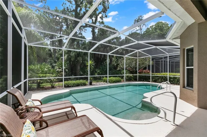 View of swimming pool featuring a lanai and a patio