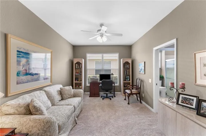 Carpeted office space with ceiling fan