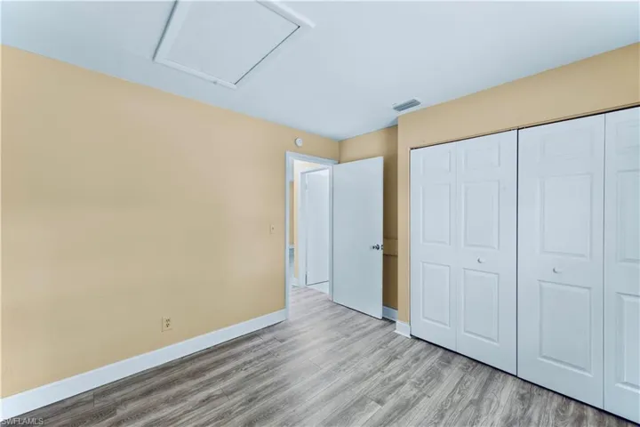 Unfurnished bedroom featuring wood finished floors and a closet