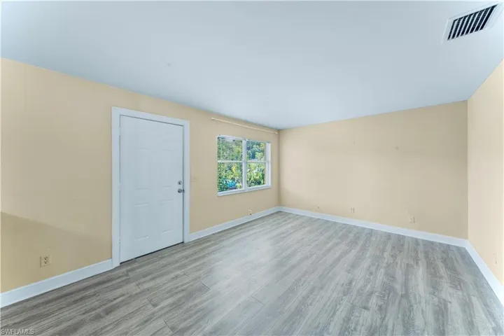 Spare room with wood finished floors and baseboards