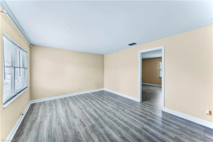 Spare room featuring wood finished floors and baseboards