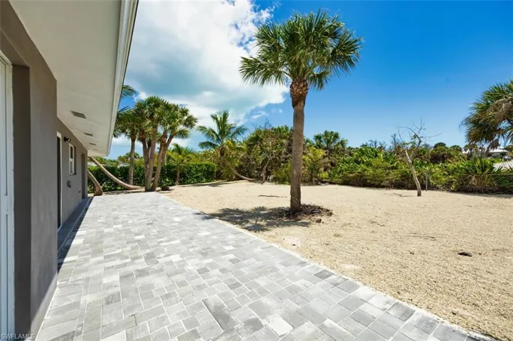 View of open patio and large backyard