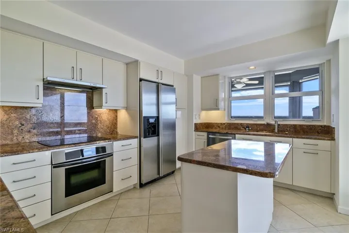 Kitchen with stainless steel appliances, a kitchen island.