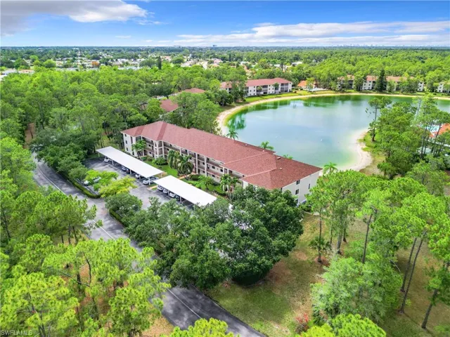 Birds eye view of property with a water view