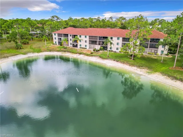 View of pool featuring a lawn and a water view