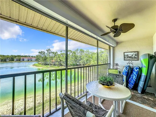 Sunroom / solarium with ceiling fan, a healthy amount of sunlight, and a water view