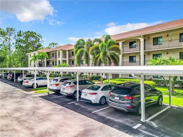 View of parking with a carport