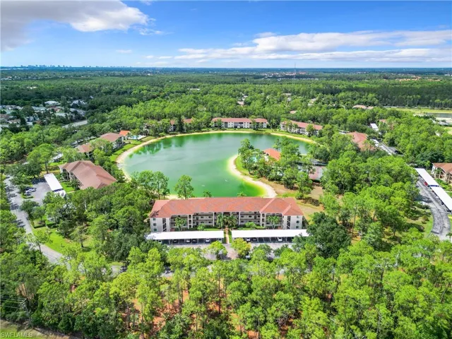 Birds eye view of property with a water view