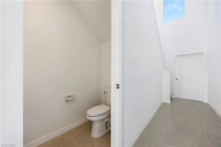 Bathroom with light tile patterned floors and baseboards