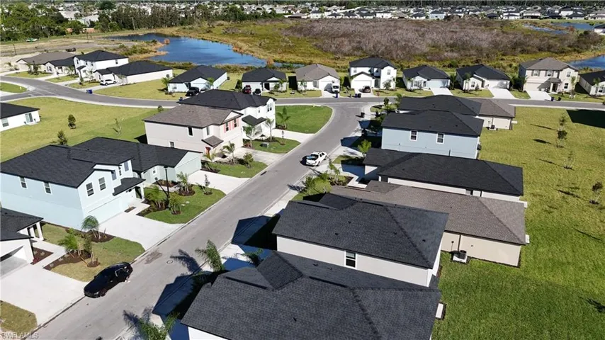 Aerial overview of property's location with a large body of water and nearby suburban area