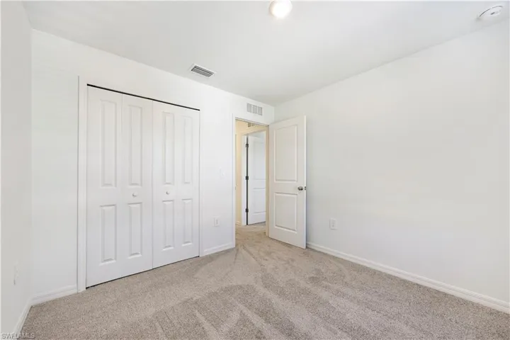 Unfurnished bedroom with carpet flooring and a closet