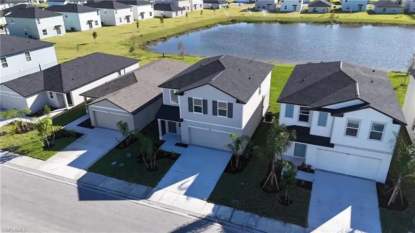 Aerial view of residential area featuring a large body of water