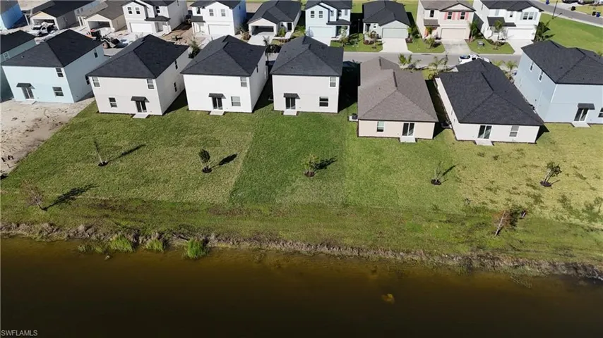 Aerial overview of property's location with nearby suburban area and a large body of water