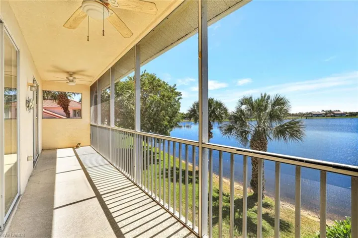 Balcony featuring a ceiling fan and a water view
