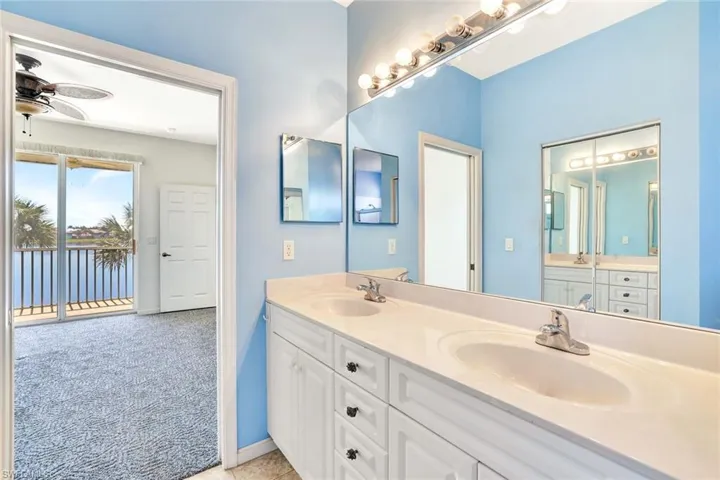 Full bathroom featuring a ceiling fan, a sink, baseboards, and double vanity